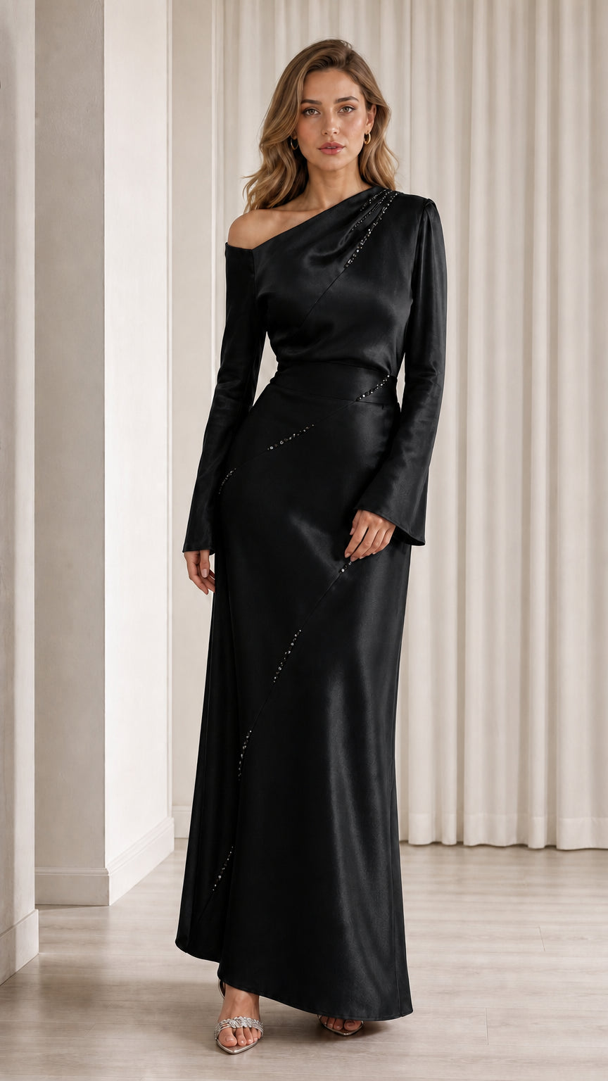 Front view of model wearing black one-shoulder satin gown