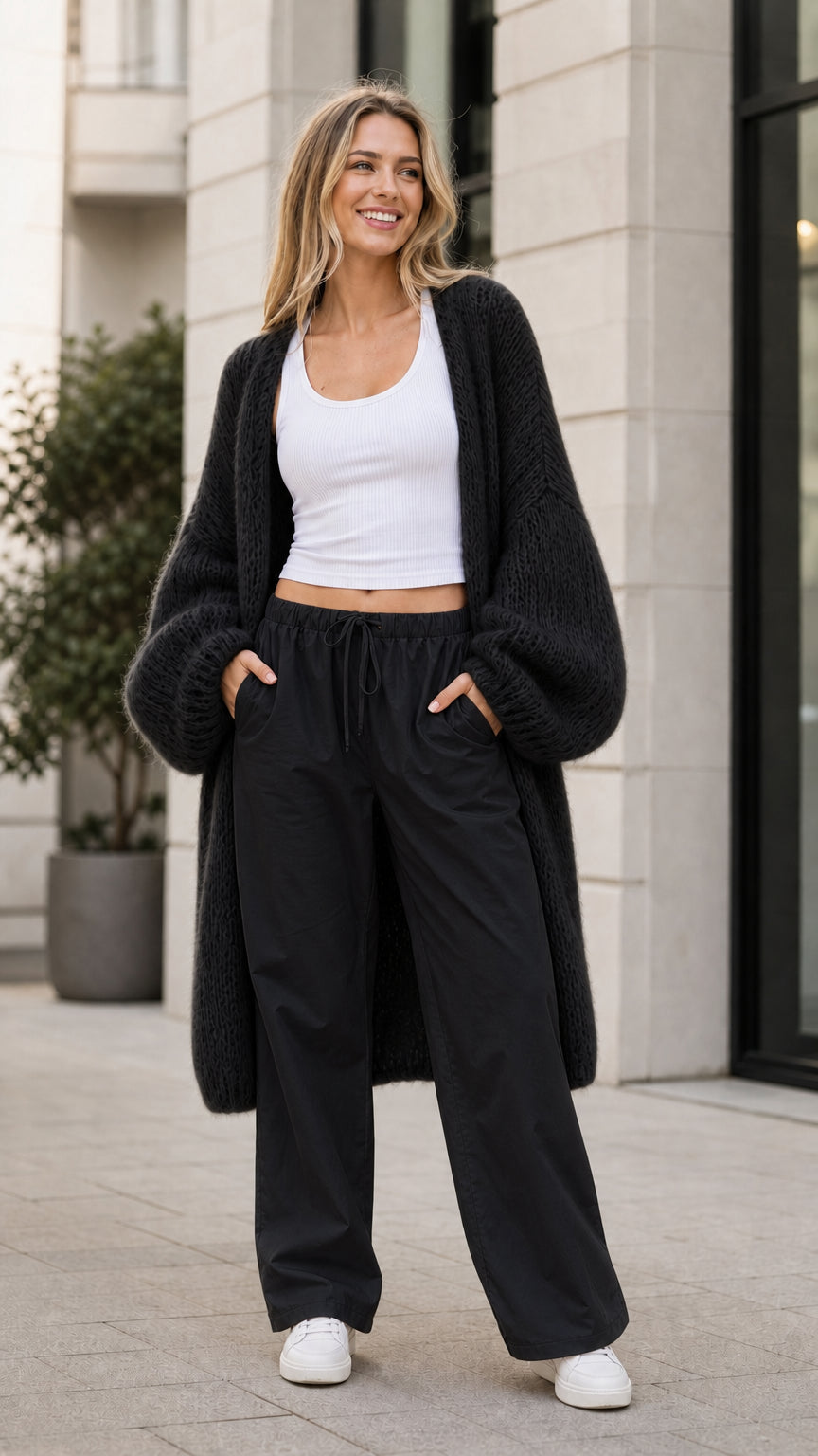 Model wearing black oversized knit cardigan