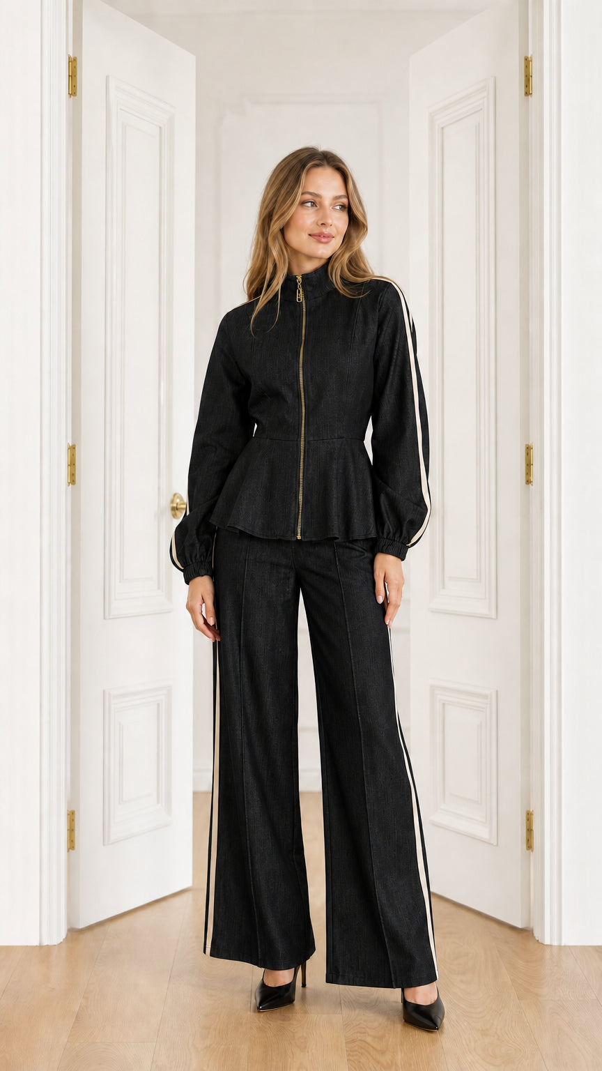 Full-length view of model wearing Black peplum jacket and wide-leg pants set with white side stripes
