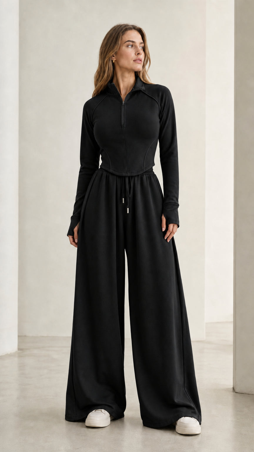 Women's black half-zip top and flowing wide-leg sweatpants two-piece set