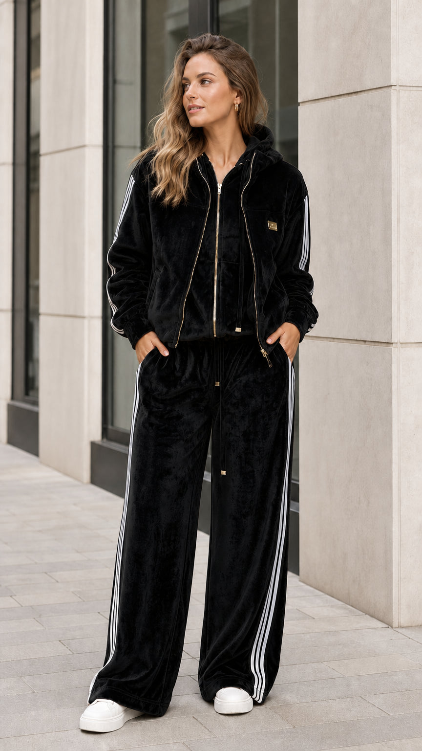 Full front view of black velour two-piece tracksuit set with white side stripes
