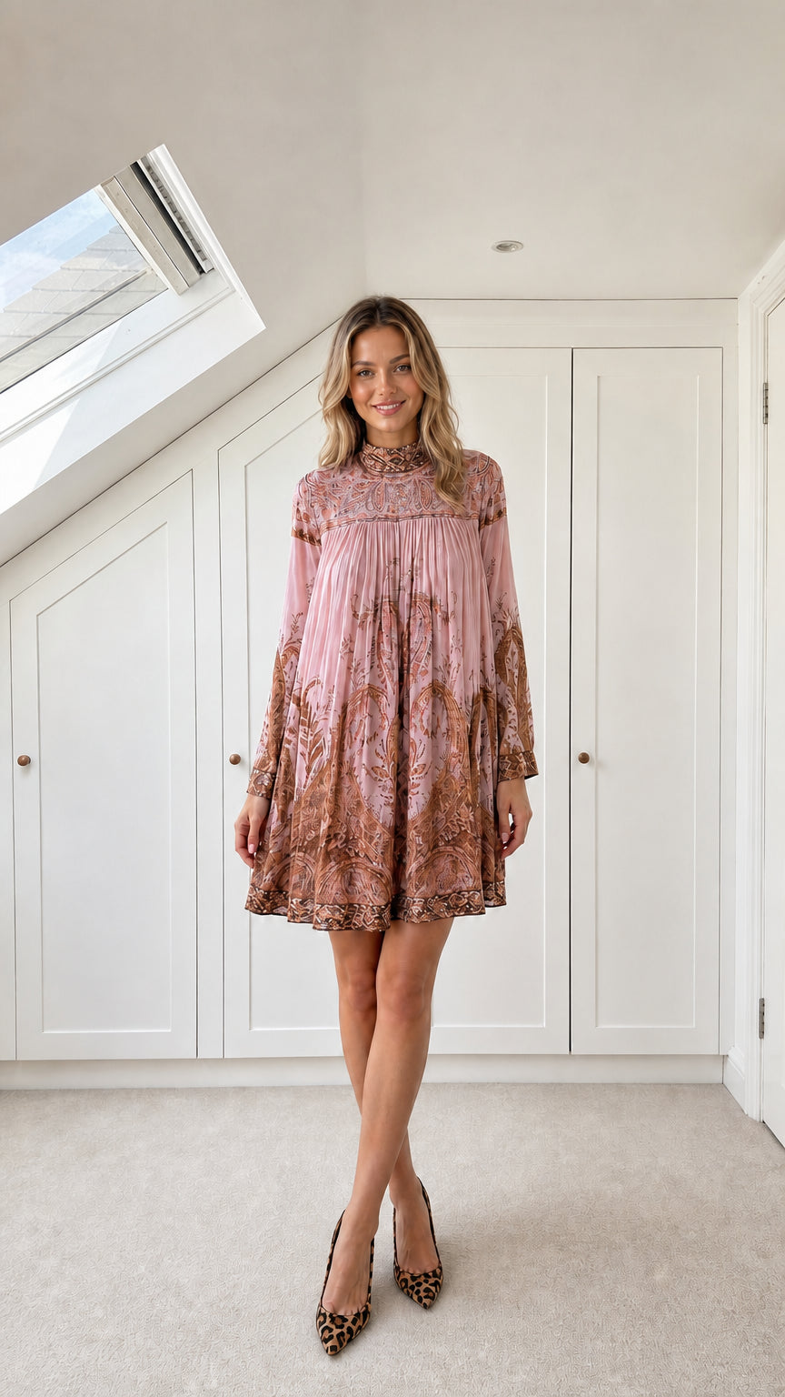 Model wearing dusty pink paisley pleated high-neck mini dress