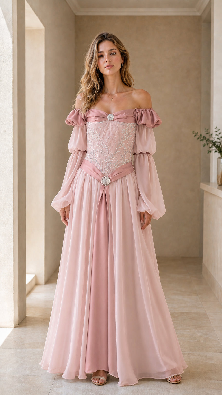 Model wearing blush pink fairy maxi gown with embroidered bodice and flowing sleeves