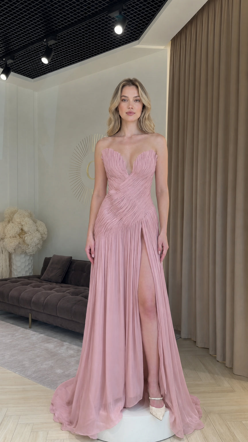 Front view of model wearing dusty rose strapless pleated formal evening dress