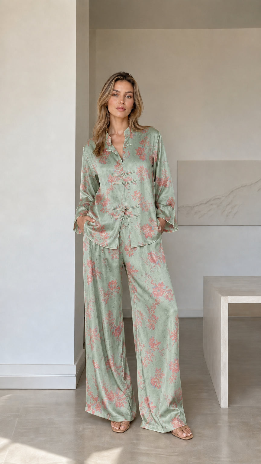 Model wearing sage green floral satin two-piece pajama set