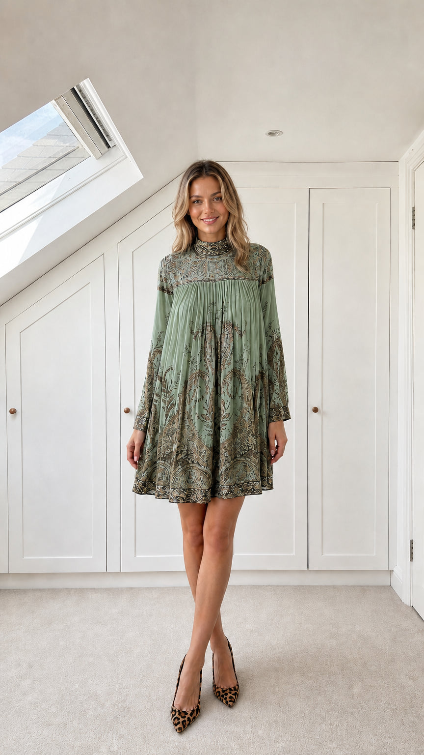Model wearing sage green paisley pleated swing mini dress