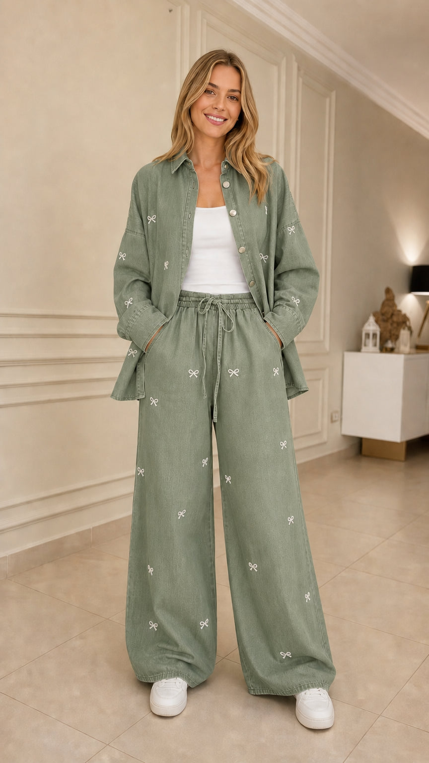 Woman wearing sage green bow embroidered denim shirt and wide leg pants set