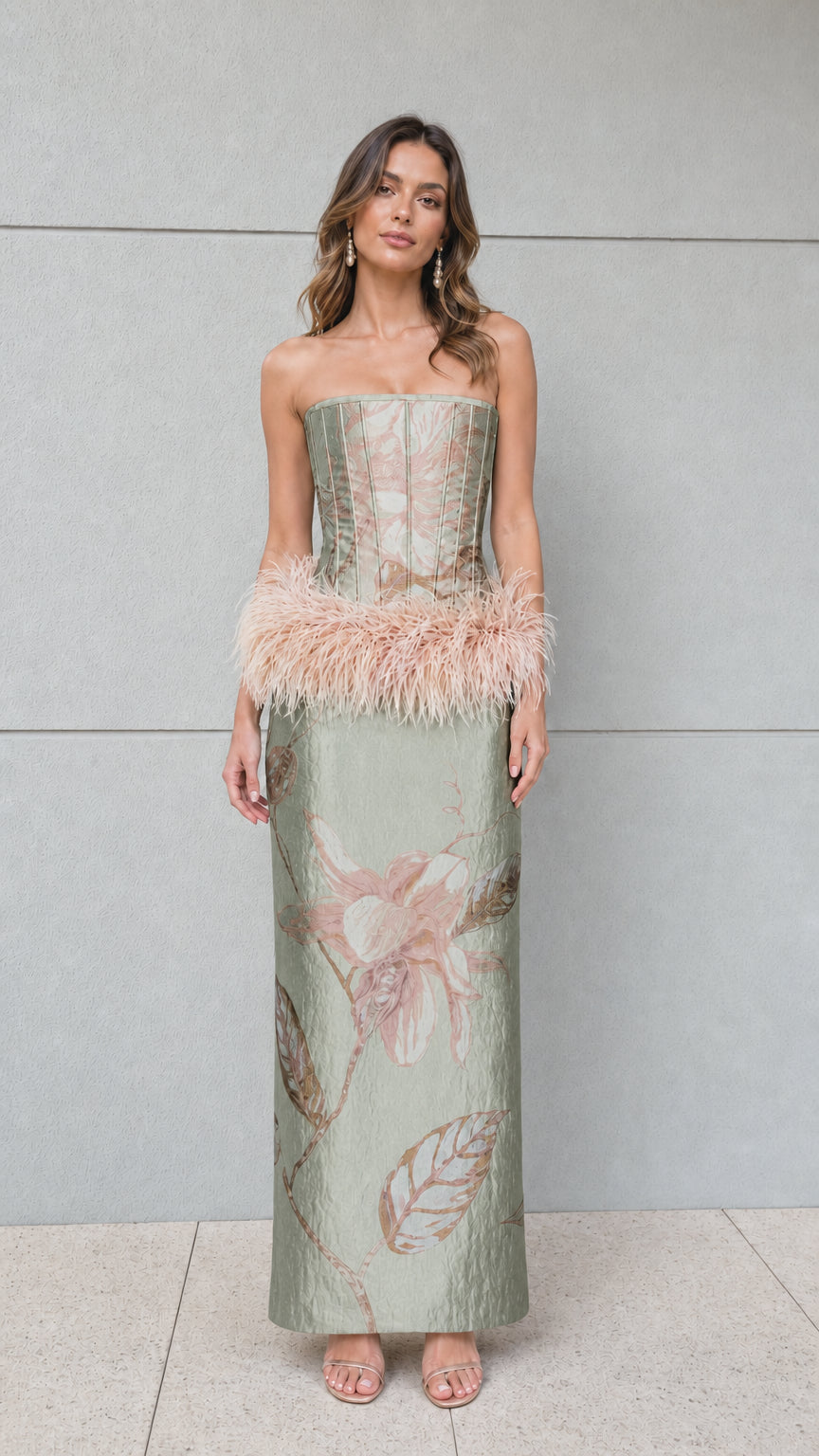 Front view of sage green floral jacquard strapless column gown with blush feather trim