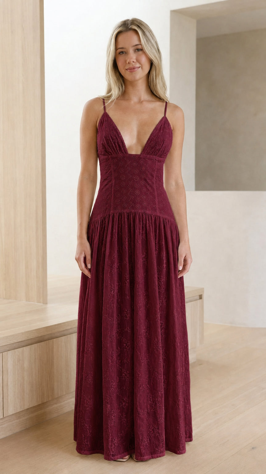 Model wearing burgundy red eyelet embroidered drop-waist maxi dress