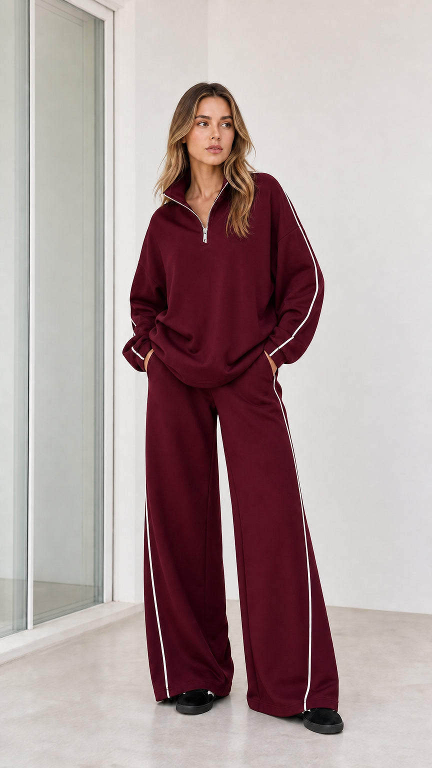 Model wearing burgundy wine half zip sweatshirt and wide leg lounge set