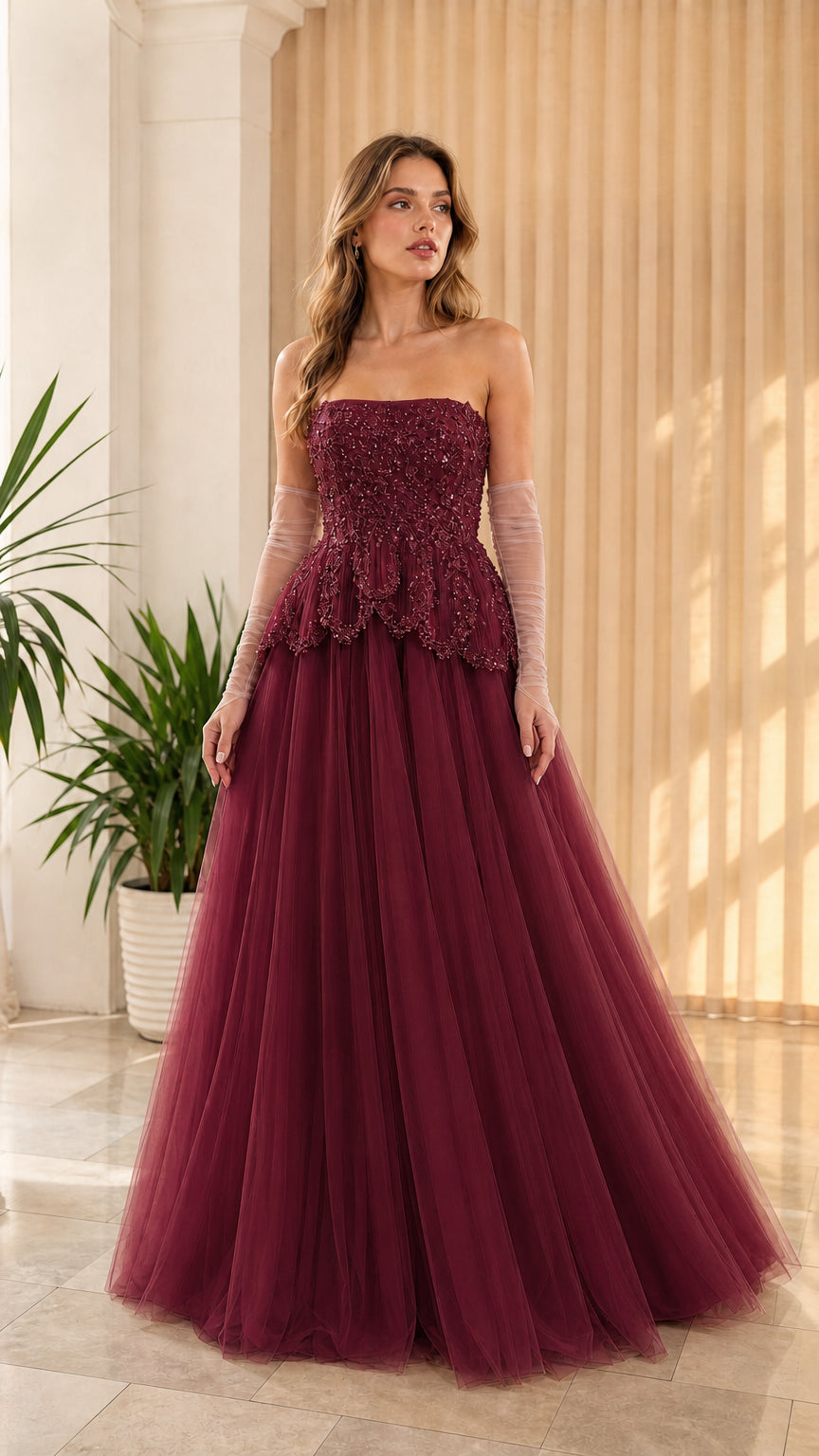 Full-length front view of burgundy wine red strapless beaded peplum tulle gown