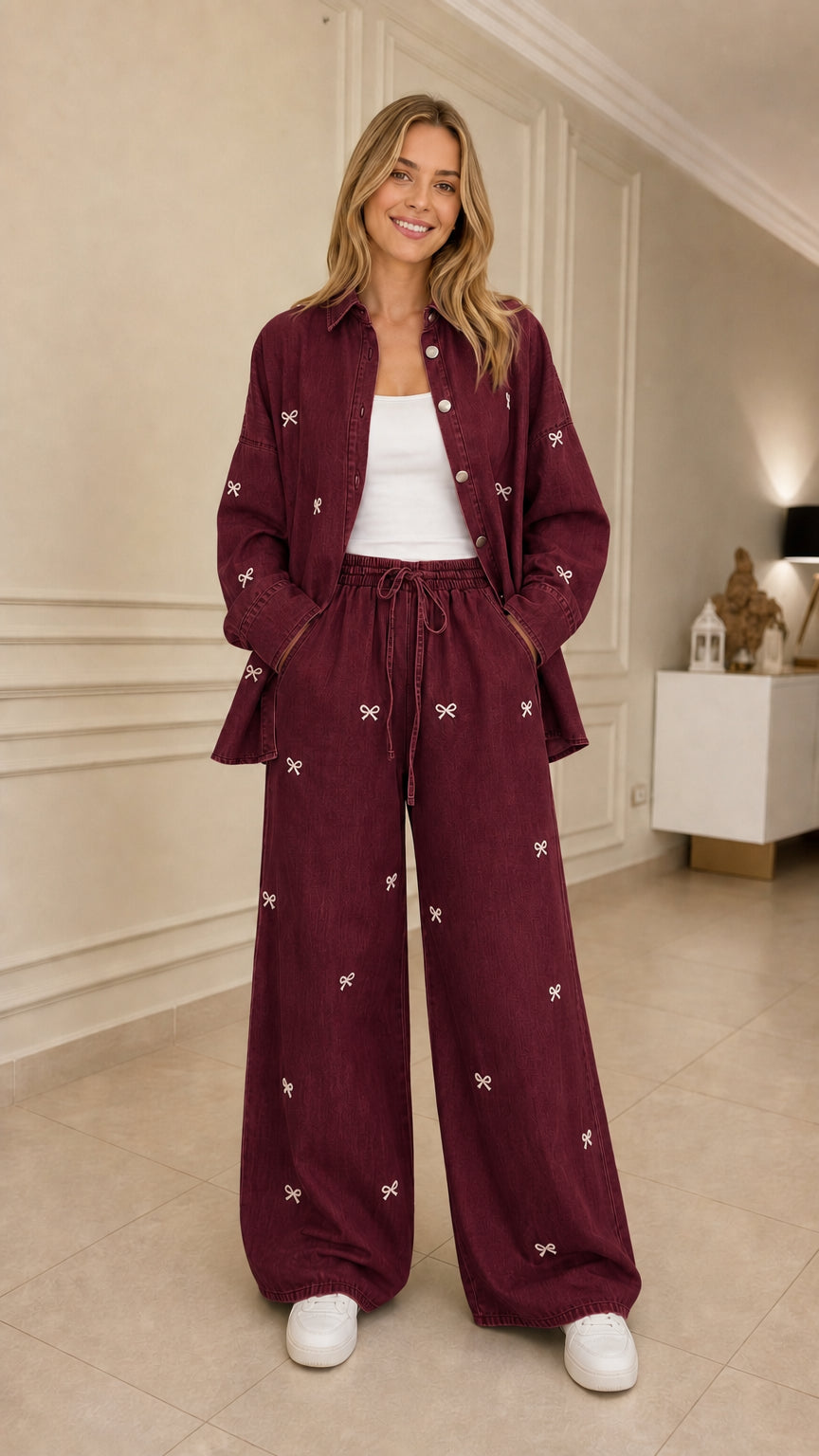 Woman wearing burgundy bow embroidered denim shirt and wide leg pants set