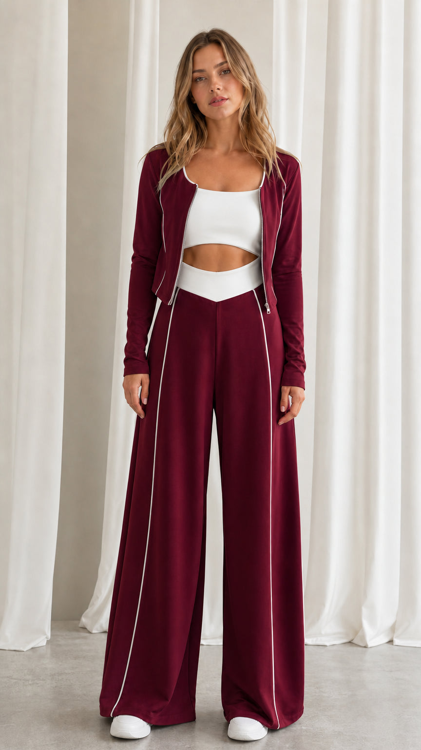 Front view of women's burgundy red 2-piece tracksuit set with contrast white piping