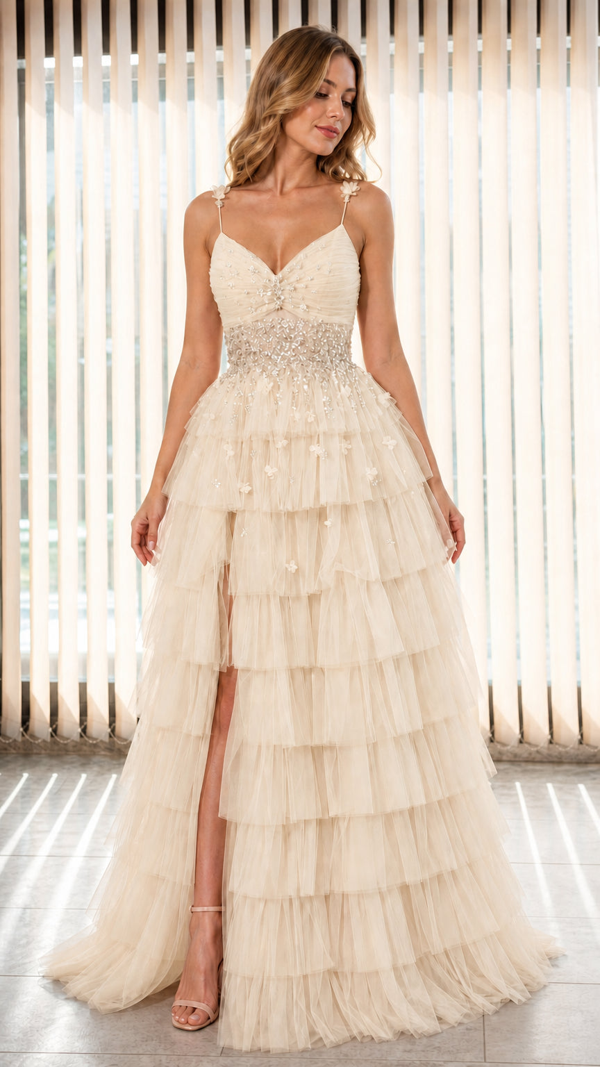 Model wearing Champagne tiered tulle evening gown with embellished waist